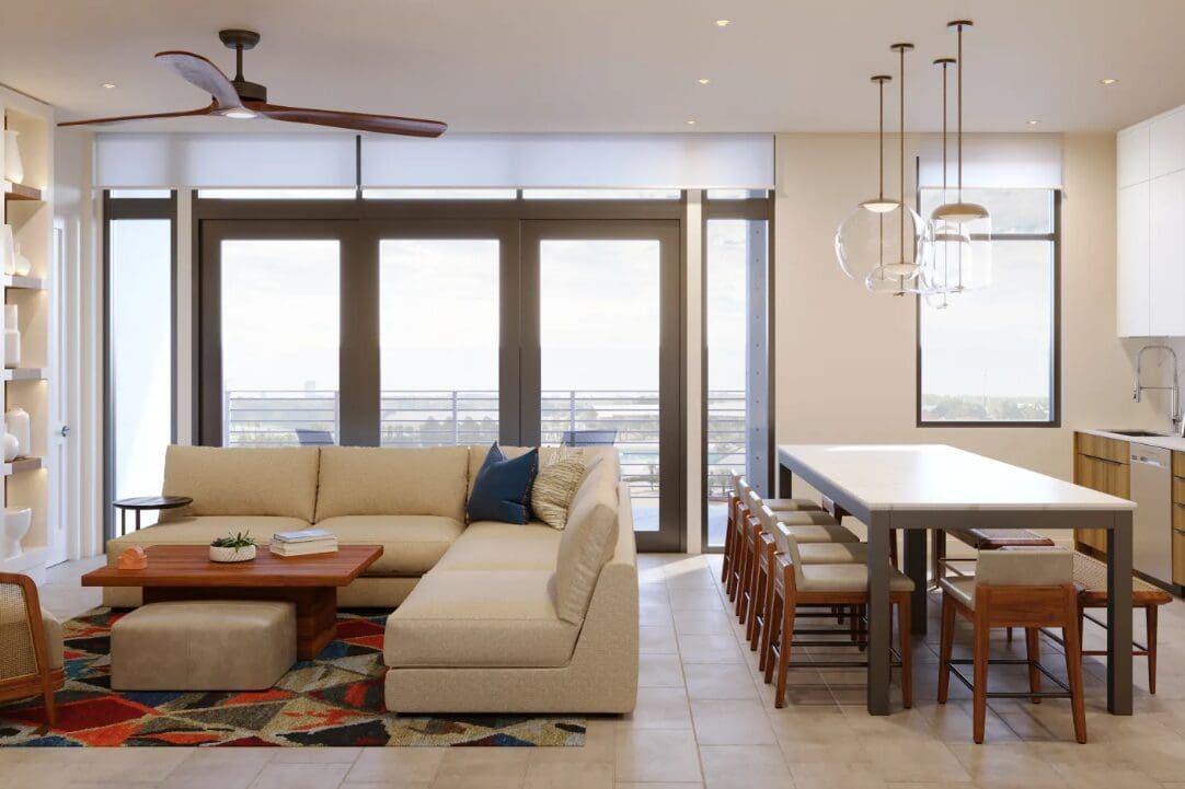 Modern living room with large windows, beige L-shaped sofa, colorful geometric rug, and wooden coffee table. Adjoined open kitchen features a long dining table with wooden chairs and pendant lights above. Neutral tones and contemporary design dominate. Modern living room with large windows, beige L-shaped sofa, colorful geometric rug, and wooden coffee table. Adjoined open kitchen features a long dining table with wooden chairs and pendant lights above. Neutral tones and contemporary design dominate.