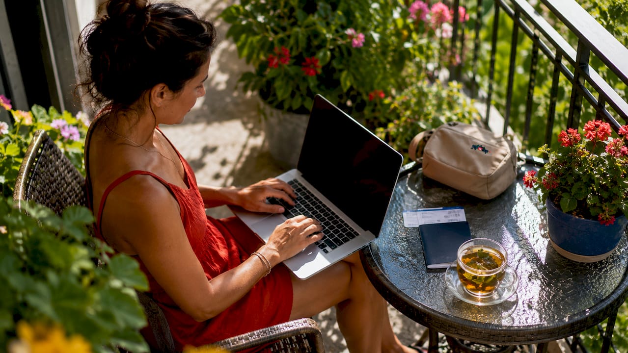 woman entering travel certificate code on laptop