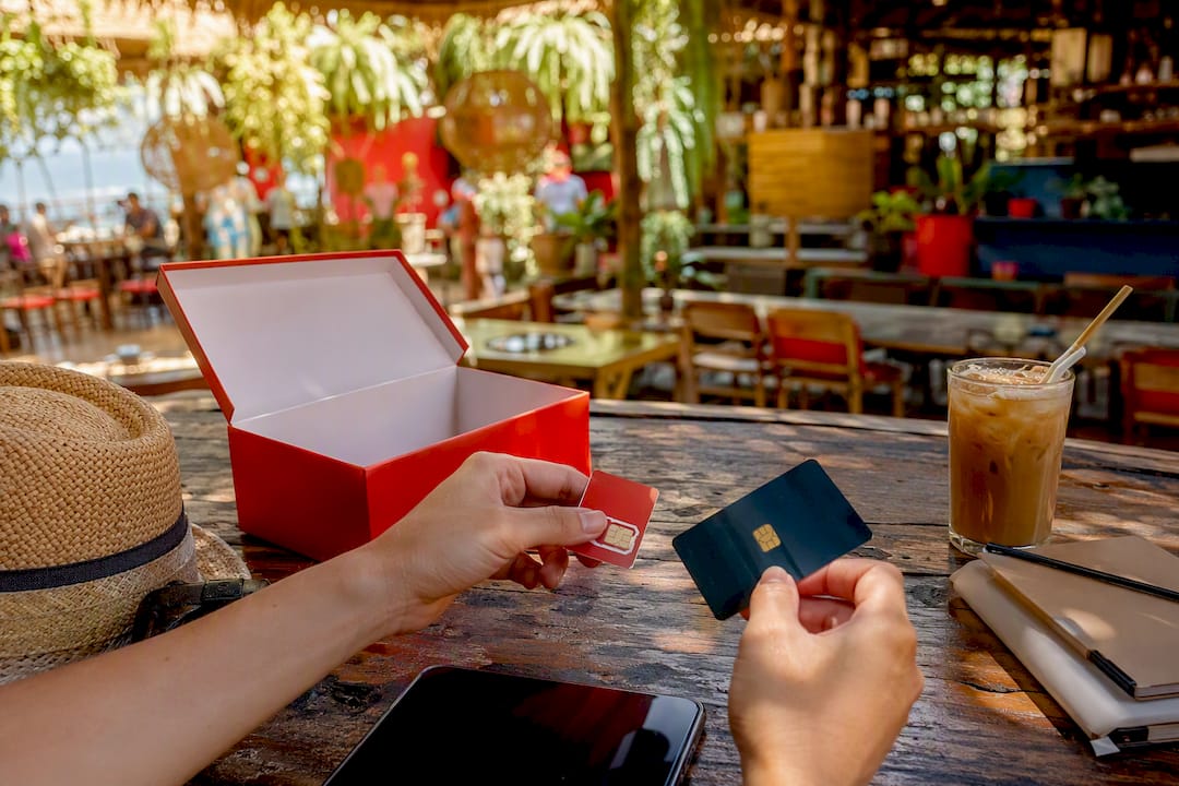 international travel gift cards: top flexible picks, 2026 3 hands placing travel add-ons by pool