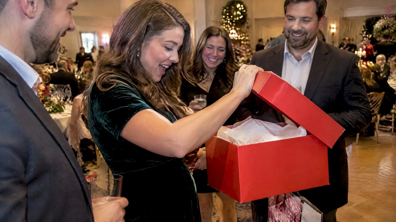 winner opening a holiday travel prize