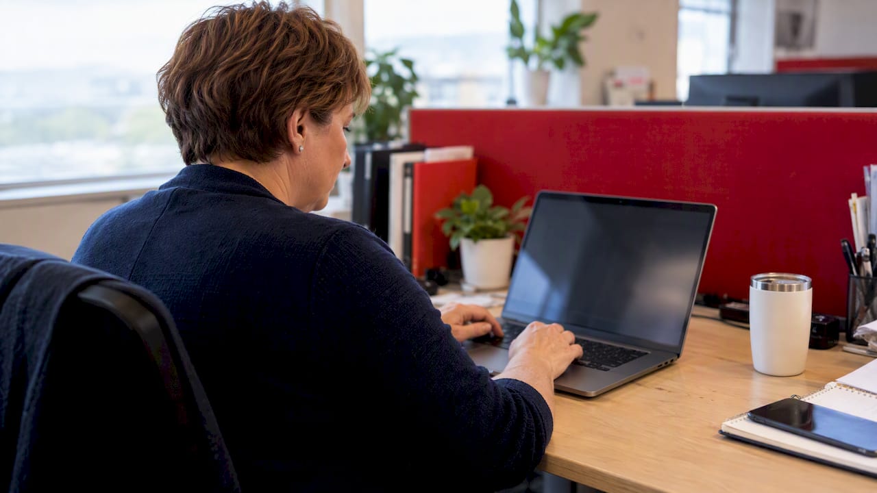 hr administrator reviewing travel incentive email