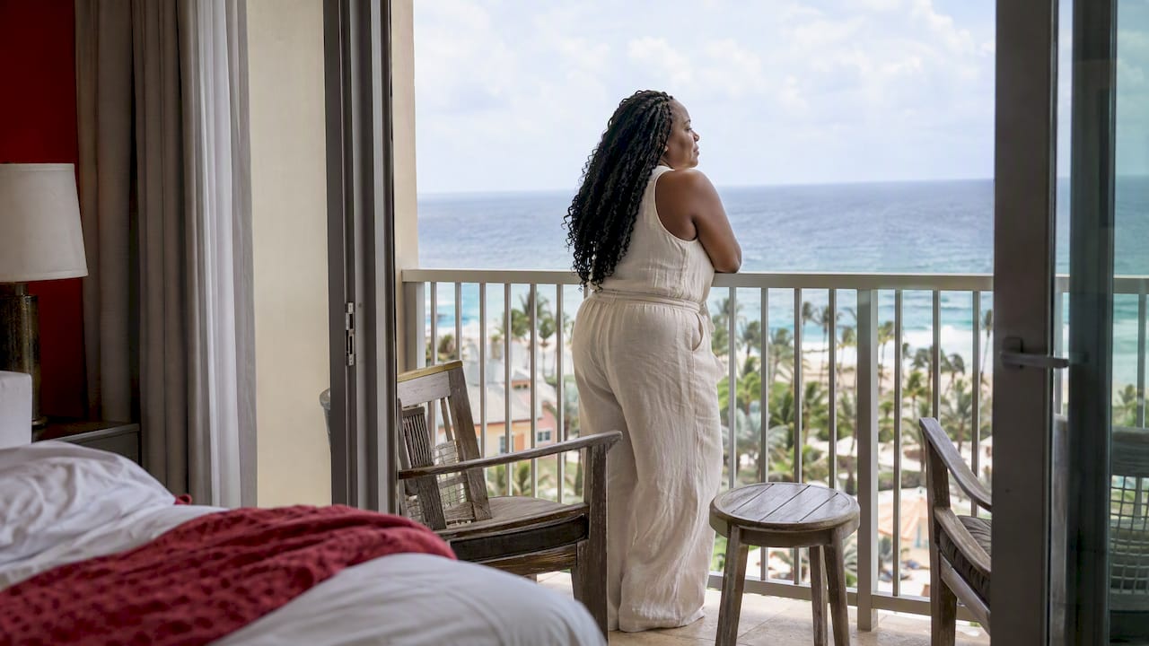 Traveler looks out from resort balcony